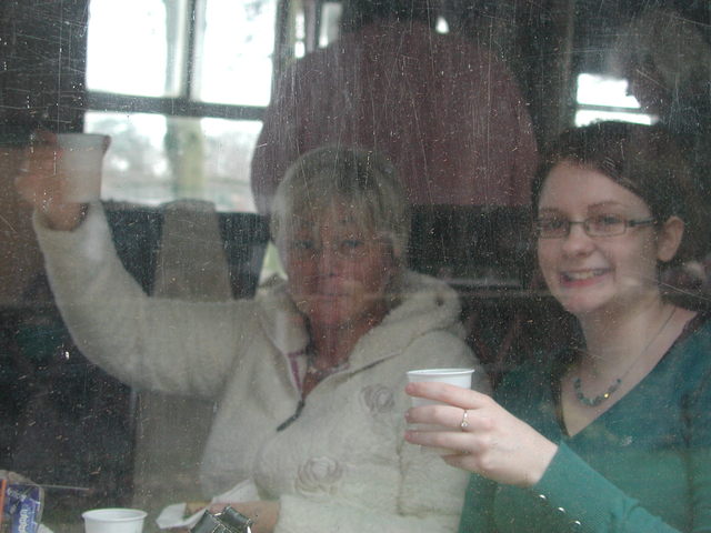 Raising their plastic cups of drinks are Cherry Quinnell and Anneka Lower. The coach windows certainly needs a clean
